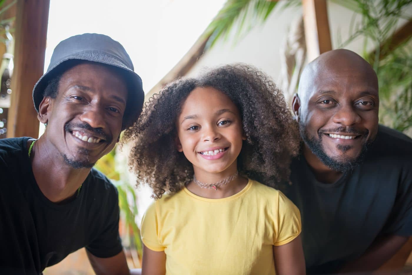Smiling girl with two men in her family