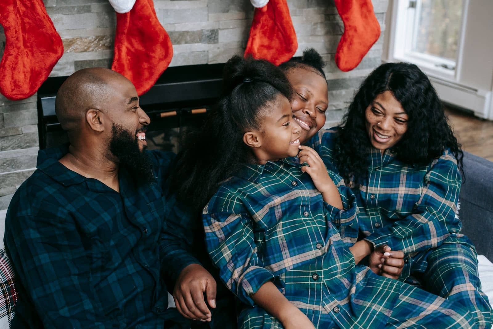 Family laughing together on the sofa